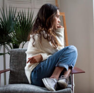 Sad thoughtful teen girl sits on chair feels depressed, offended or lonely, upset young woman suffers from abuse, harassment or heartbreak, grieving lady or violence victim has psychological problem and is ready to receive care at Brain First Family Center in Kansas City, MO